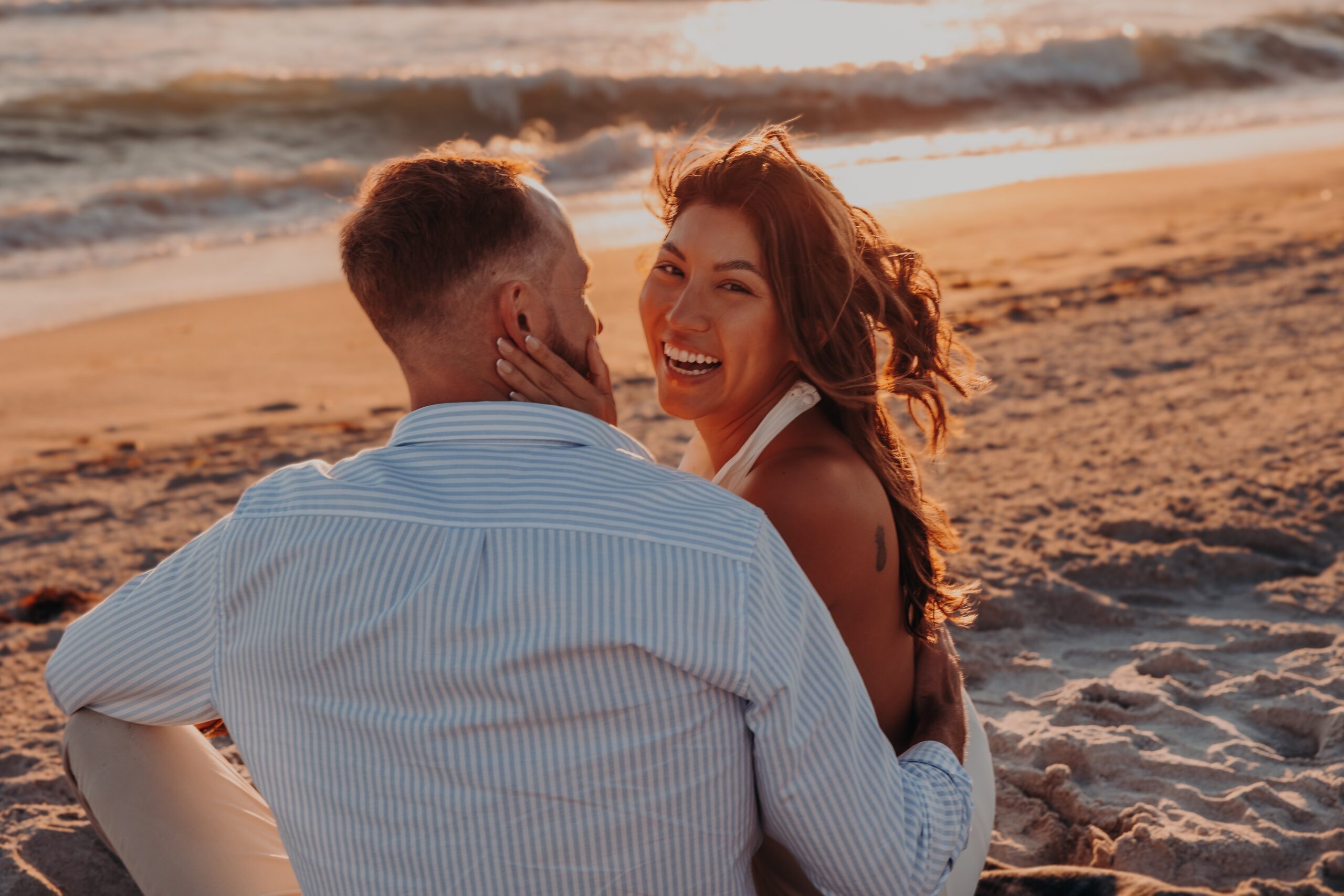 Bianca and Patrick intimate portrait on Longboat Key beach at golden hour, newly engaged couple glowing in warm sunset light, photographed by Angela Moon Photography