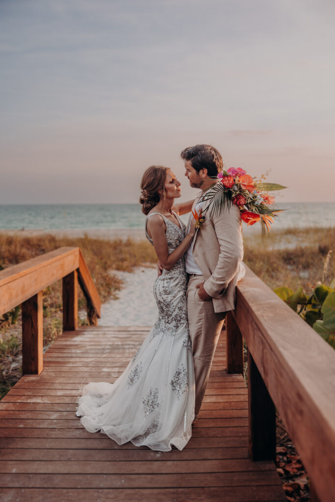 Bride and groom walking along the shoreline at Zota Beach Resort wedding in Sarasota