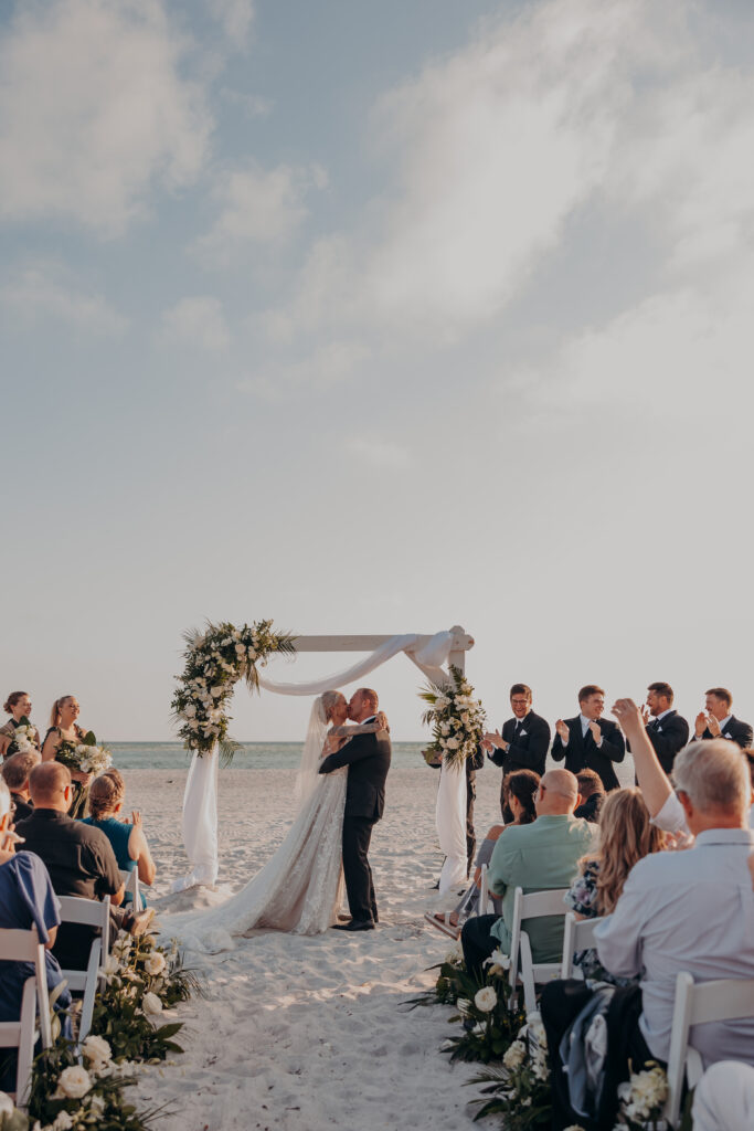 Wedding ceremony on the beach at The Resort at Longboat Key Club in Sarasota, photographed by Angela Moon Photography.