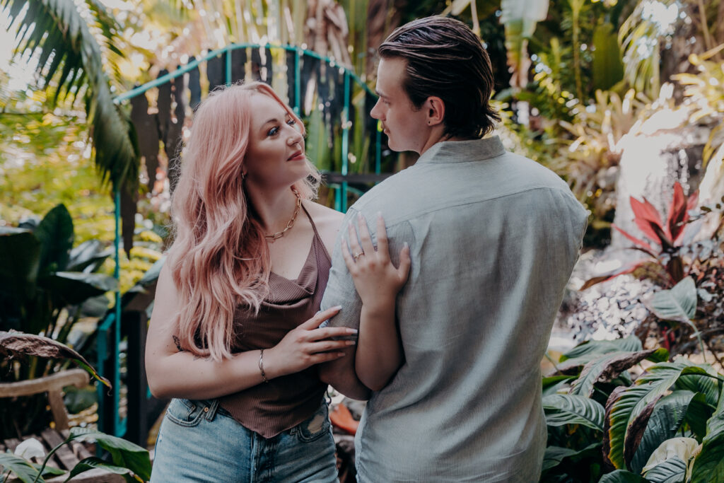 Romantic couple walking through Selby Botanical Gardens Sarasota engagement session