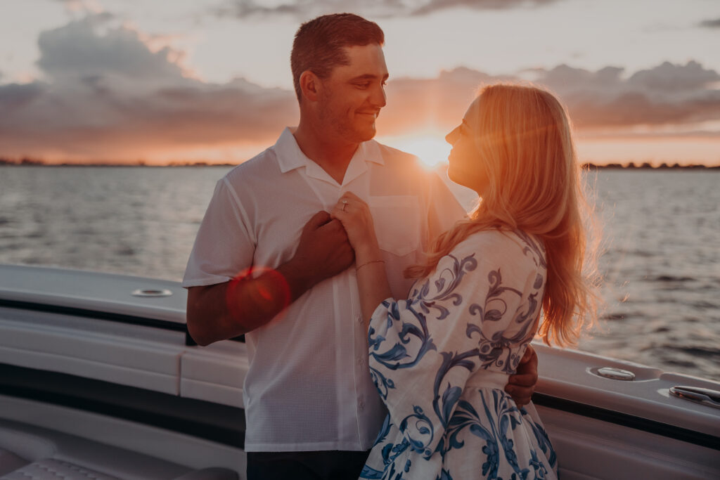Couple celebrating proposal on a boat at sunset in downtown Sarasota