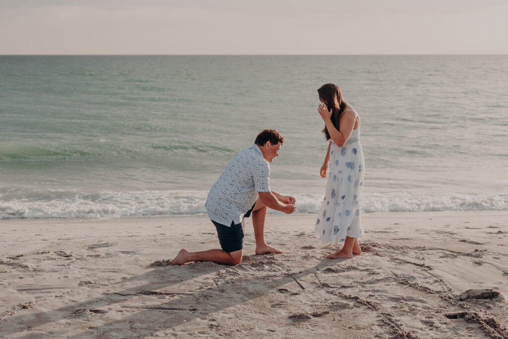 Man proposing on beach in Longboat Key Florida at sunset