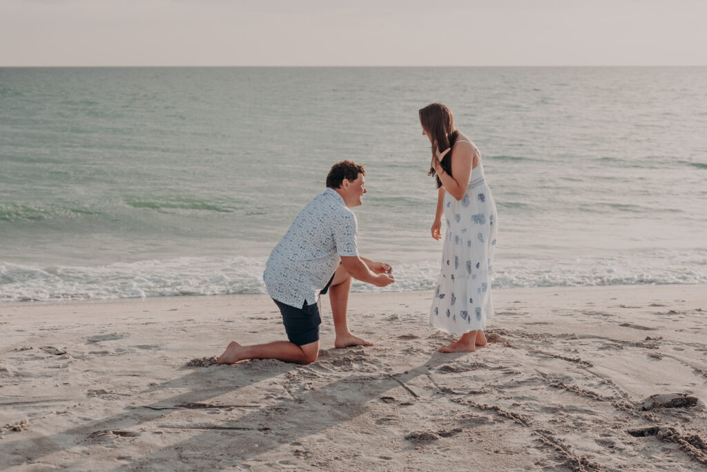 Beach proposal moment in Longboat Key Florida with couple at sunset