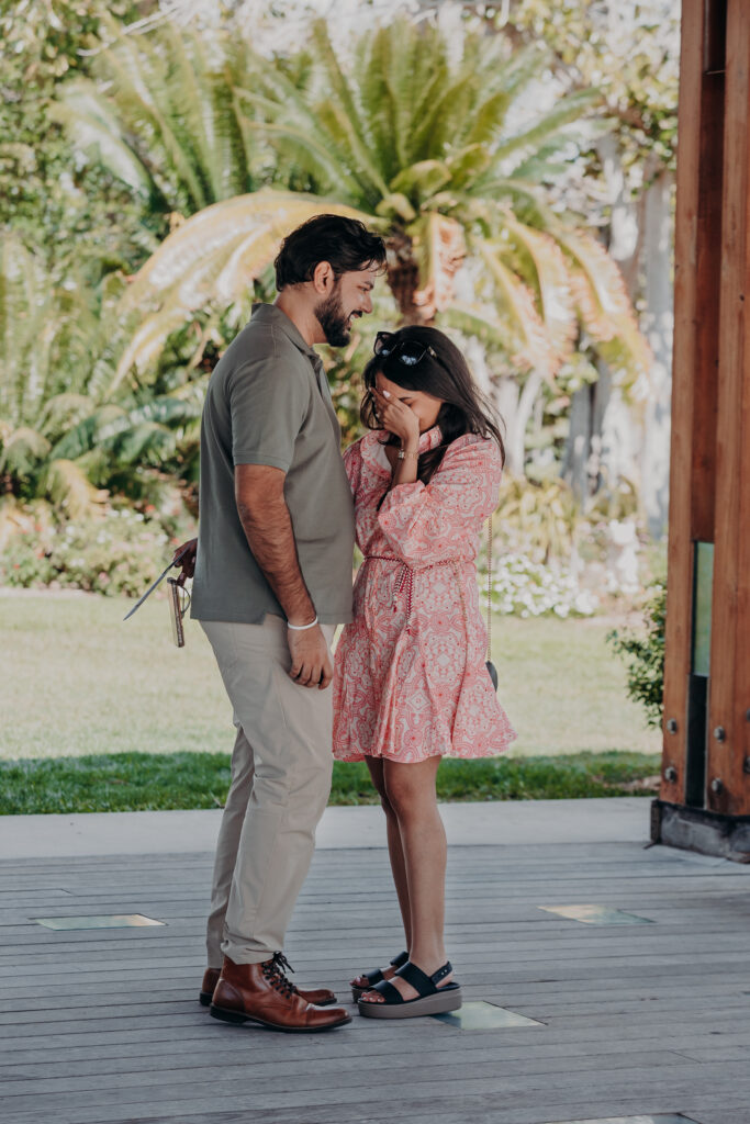 Couple embracing at pavilion after proposal in Sarasota