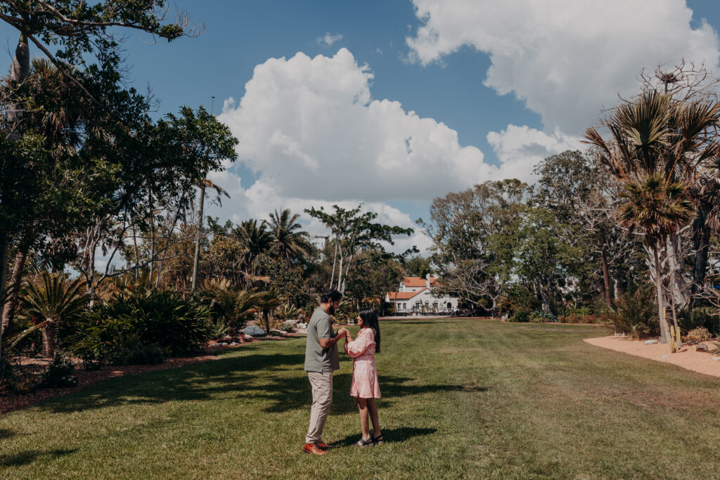Couple walking through gardens at Selby Botanical Gardens in Sarasota before proposal