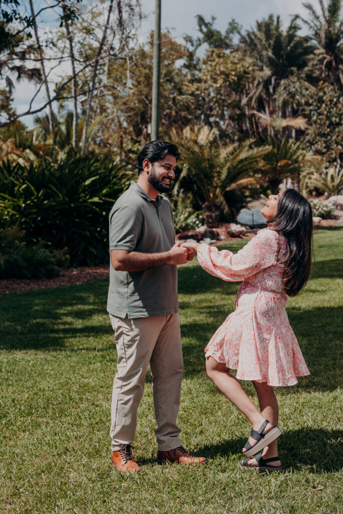 Playful couple moment during proposal session at Selby Gardens Sarasota