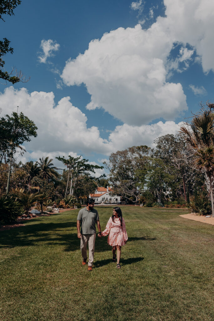 Couple walking together through open lawn at Selby Botanical Gardens Sarasota