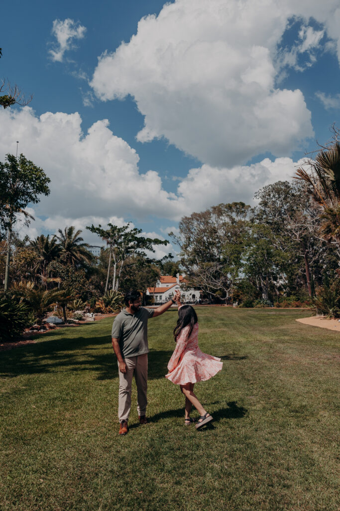 Wide view of Selby Botanical Gardens lawn with couple walking together
