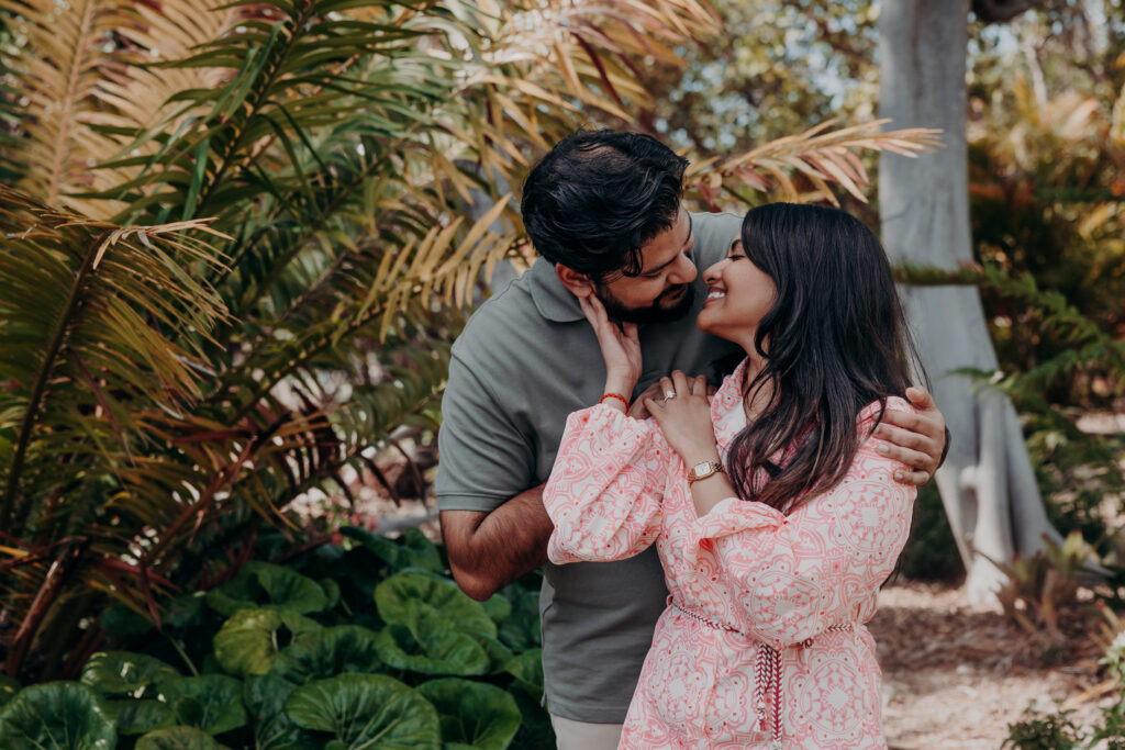 Couple embracing in tropical greenery during Selby Botanical Gardens proposal in Sarasota