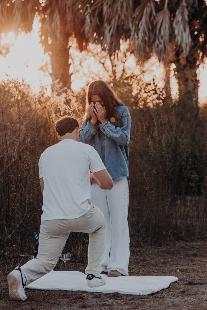 Proposal at Celery Fields Sarasota with man down on one knee at sunset