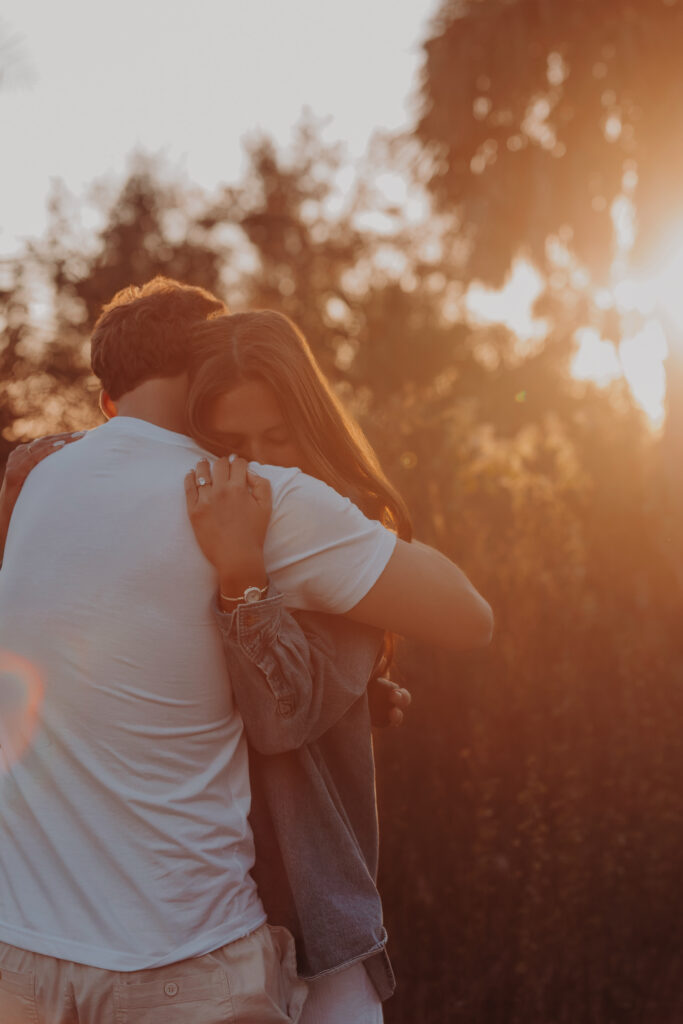 Just engaged couple hugging at sunset at Celery Fields in Sarasota
