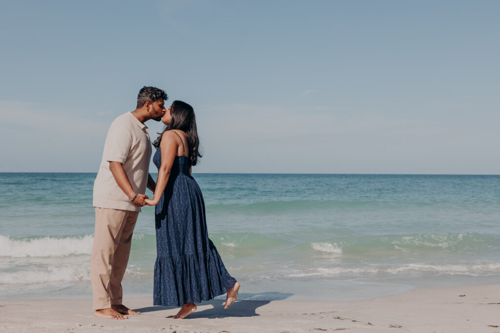 Luxury beach proposal at St. Regis Longboat Key Sarasota with couple kissing by the ocean