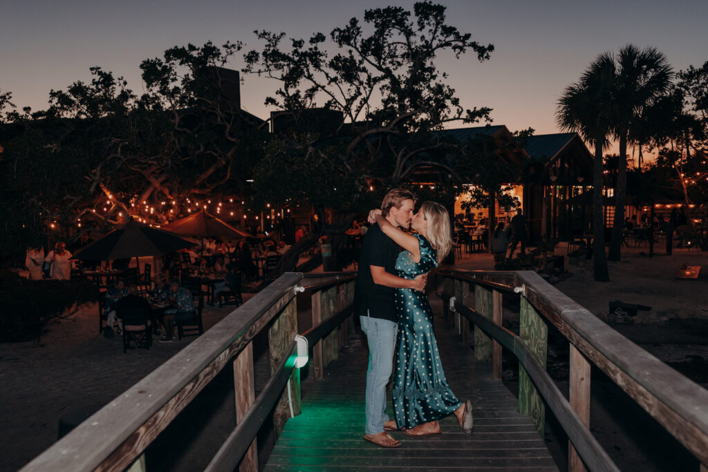 Couple embracing on dock at Mar Vista Longboat Key during proposal evening