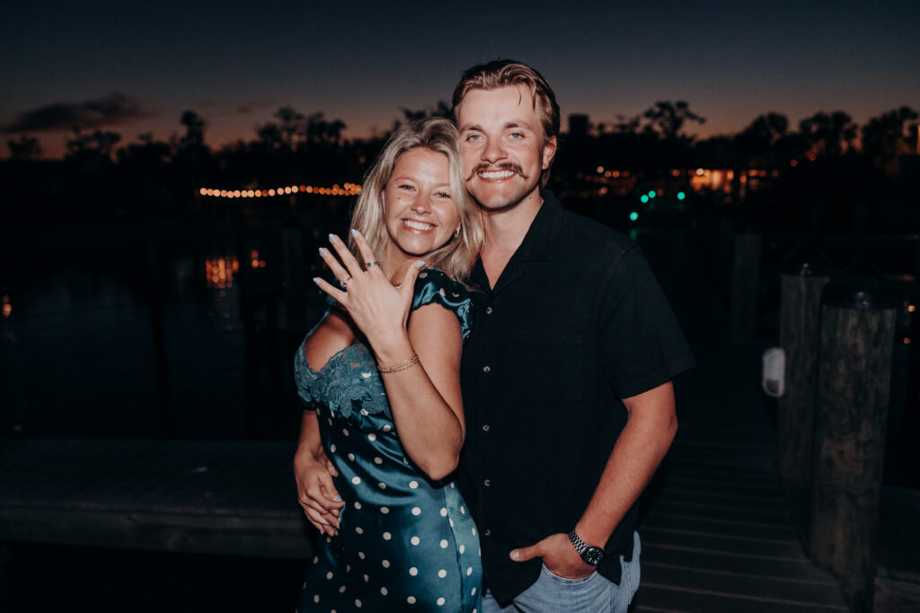 Engaged couple showing ring at Mar Vista Longboat Key after proposal