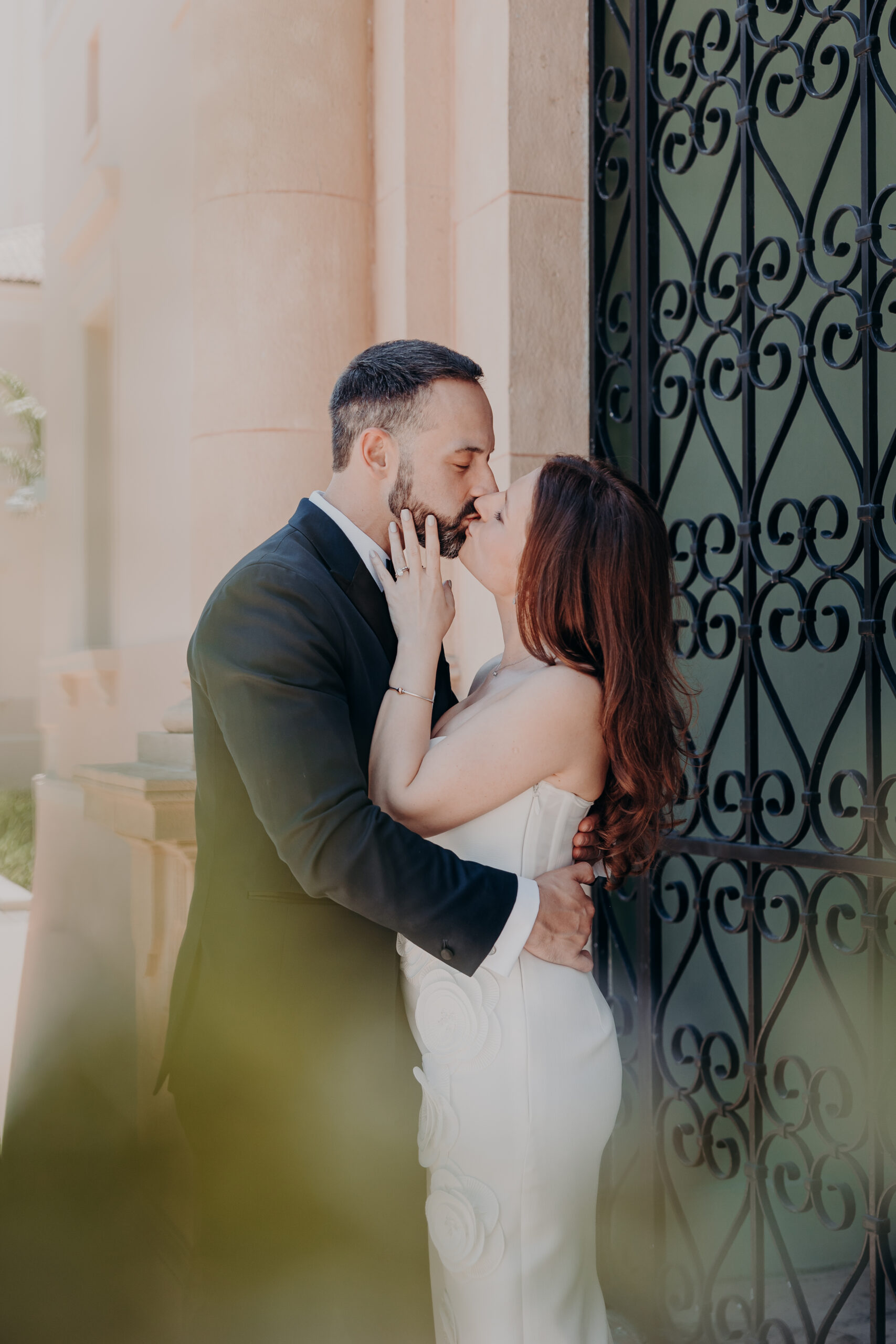 Diana and Robert sharing an intimate moment at the iron gates during their Sarasota courthouse wedding in Sarasota Florida