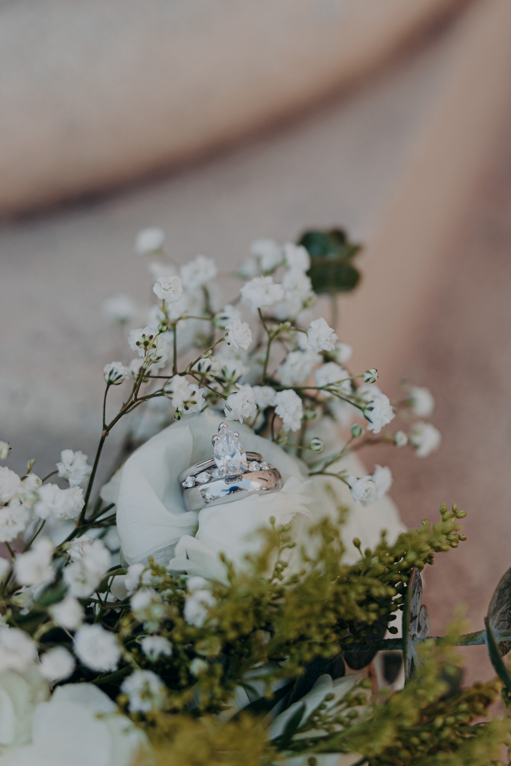 Wedding rings resting in the bridal bouquet at Diana and Roberts Sarasota courthouse wedding in Sarasota FL
