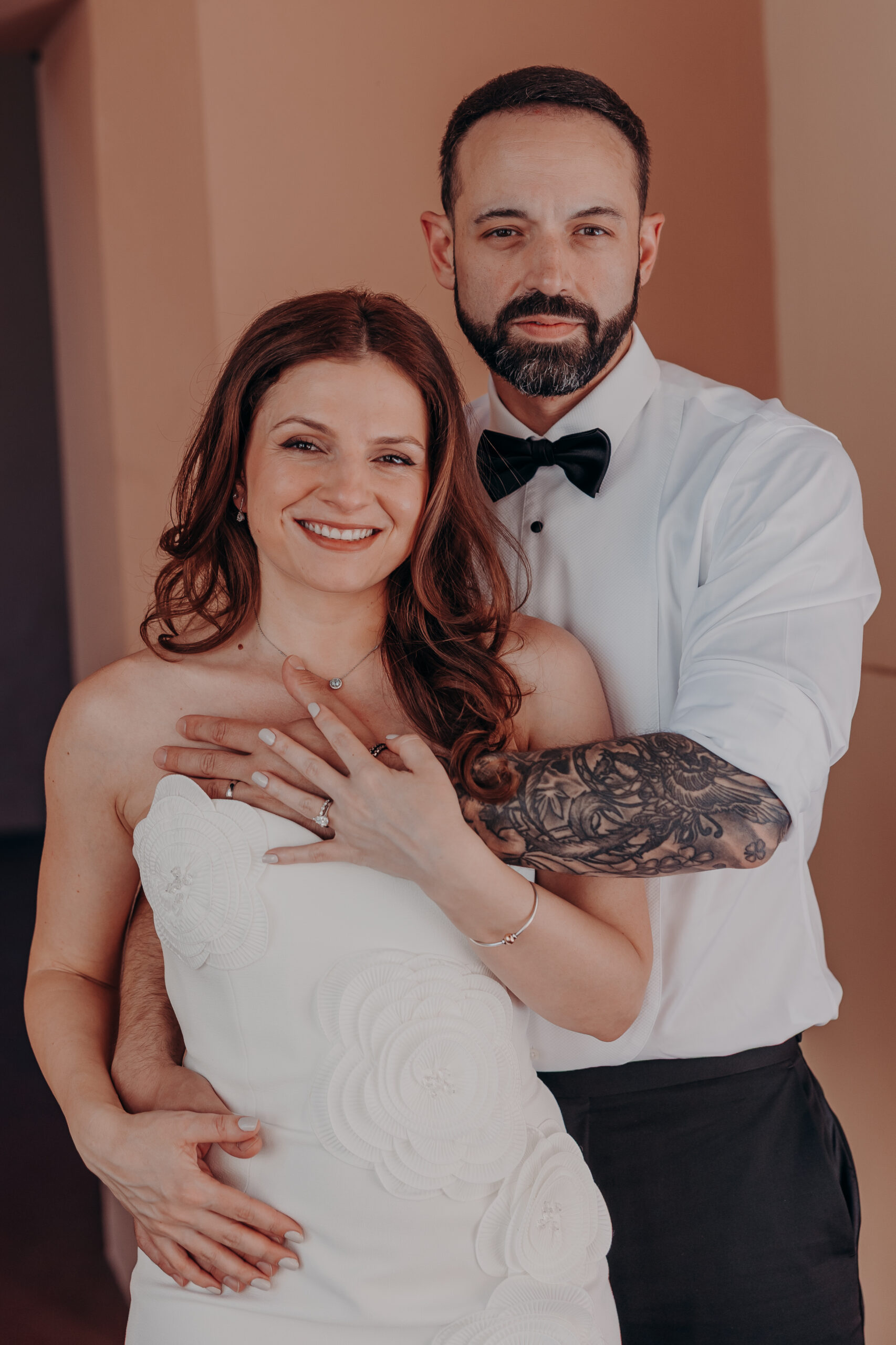 Diana smiling as Robert hugs her from behind in an intimate indoor portrait at their Sarasota courthouse wedding