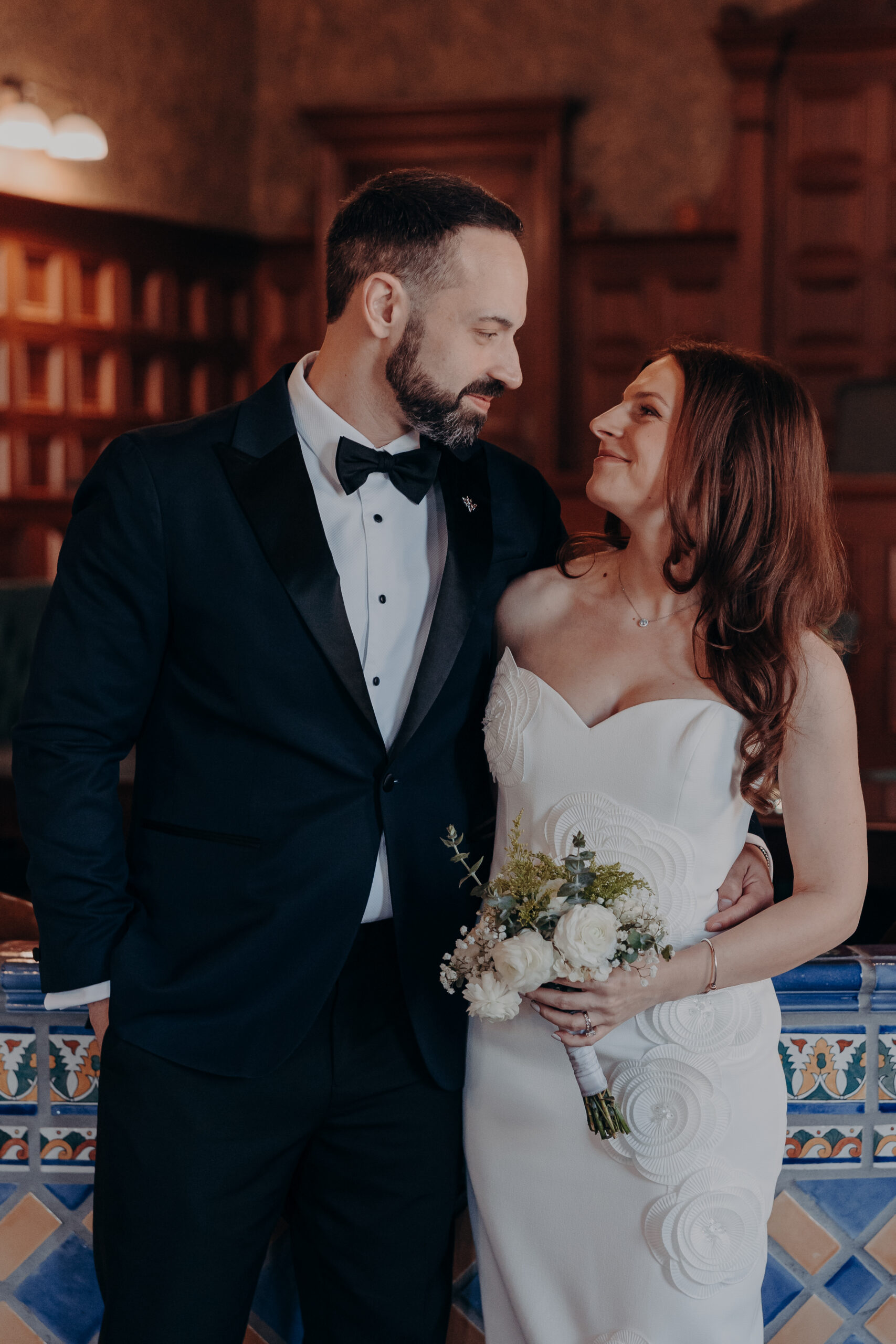 Close indoor portrait of Diana and Robert gazing at each other inside the historic Sarasota courthouse library room