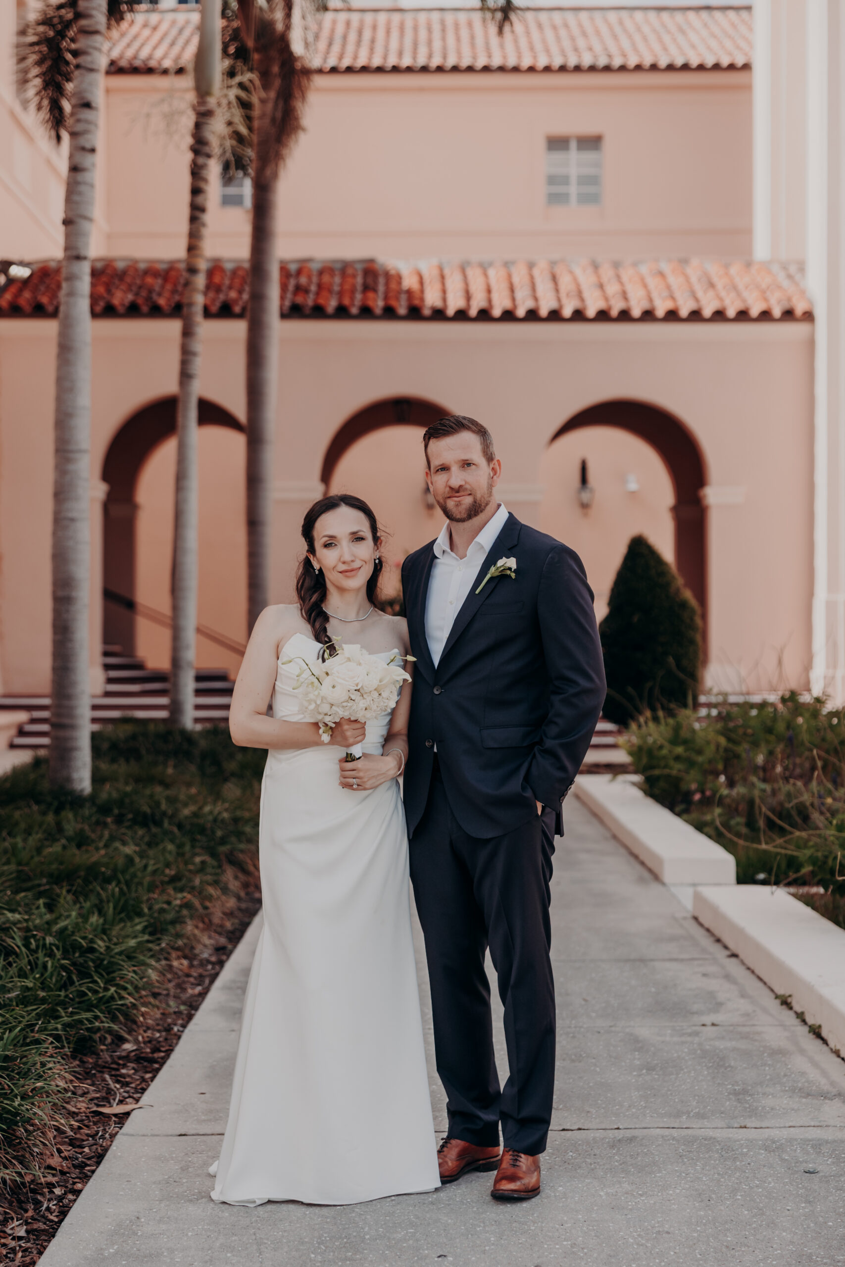 Liza and Will final kiss at the Sarasota courthouse as the morning sun warms the stone columns behind them