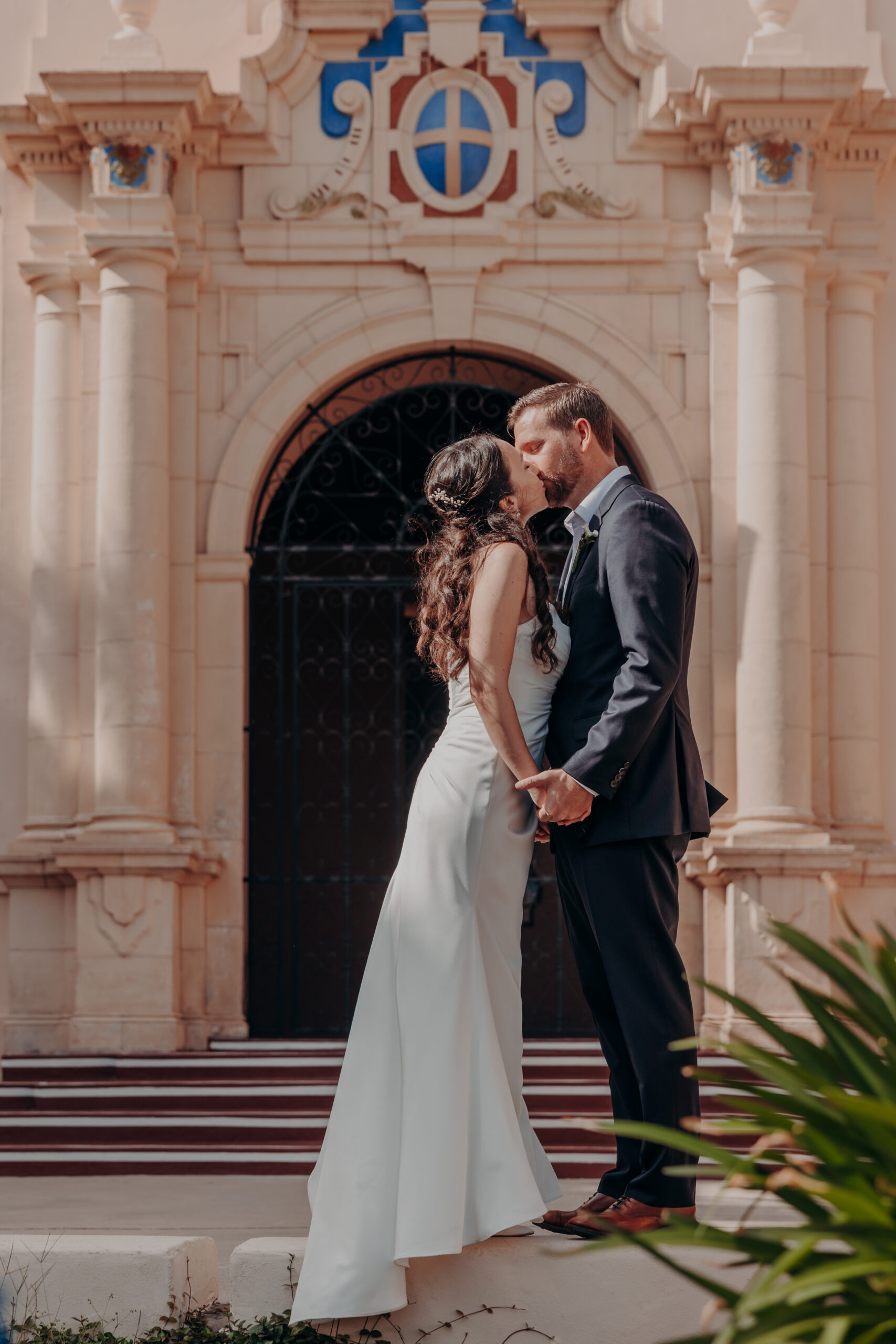 Liza and Will walking hand in hand through the Sarasota courthouse courtyard after their elopement ceremony