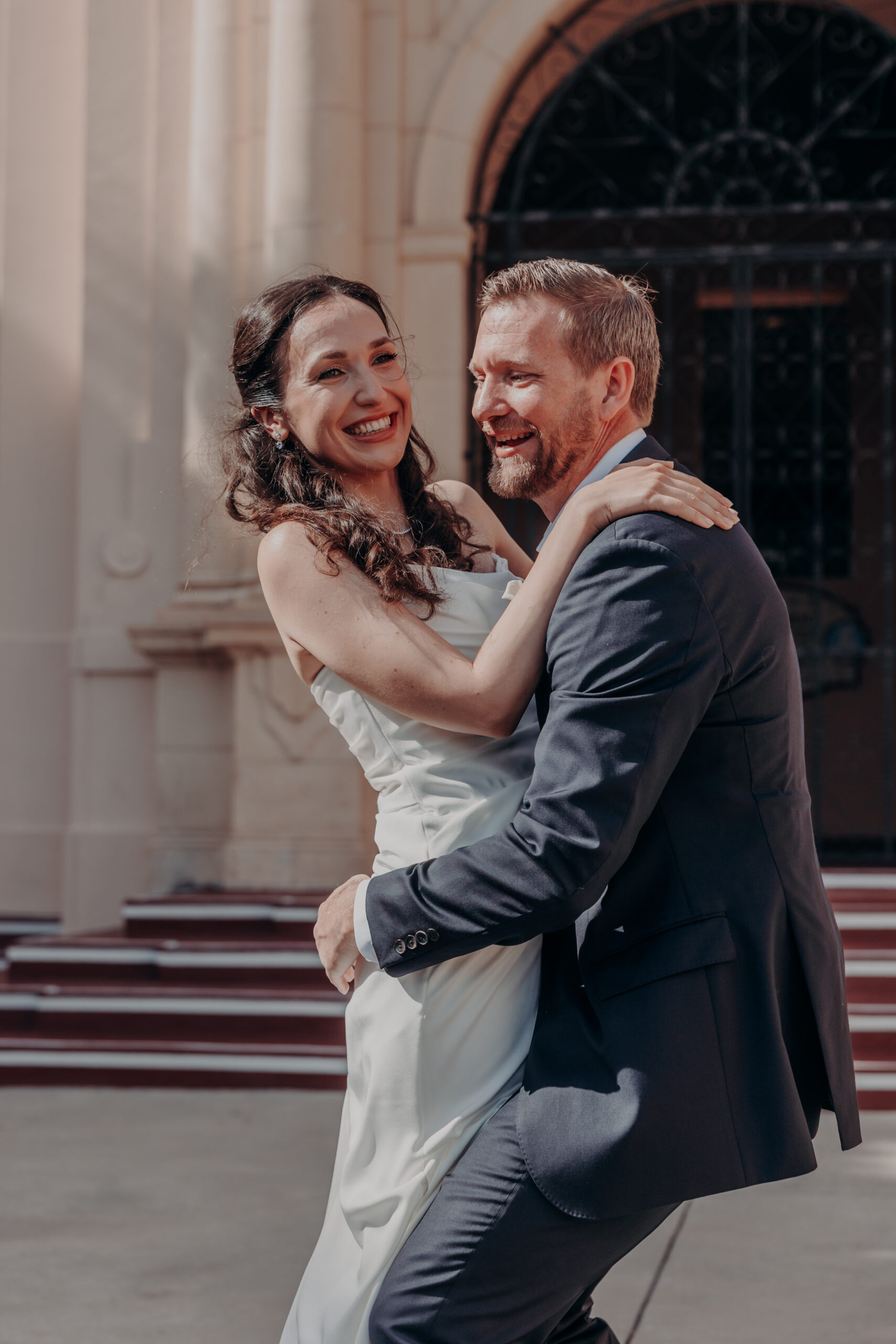Liza fixing Will's tie on the steps of the Sarasota courthouse before their wedding ceremony