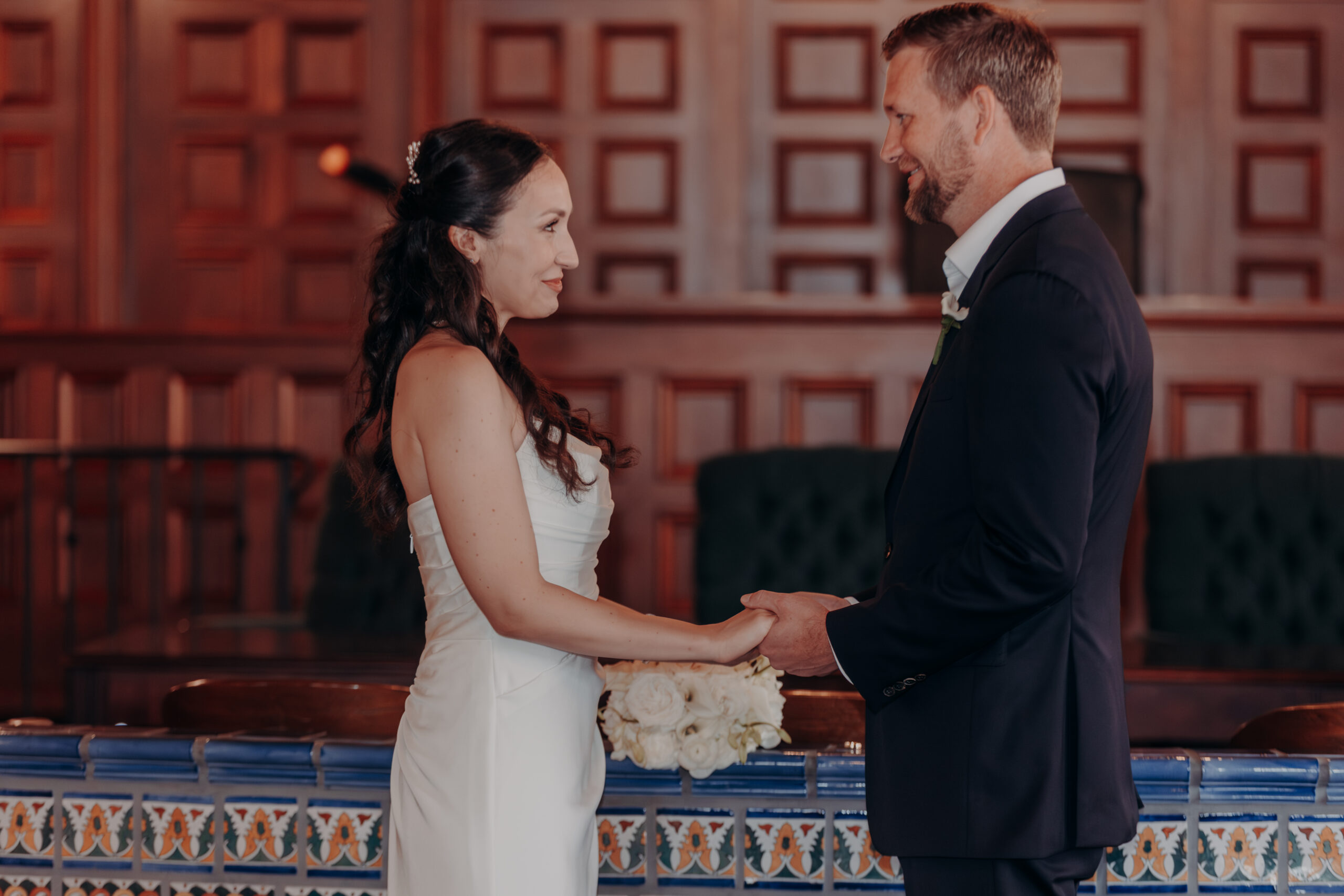 Liza and Will laughing together outside the Historic Sarasota County Courthouse on their wedding morning