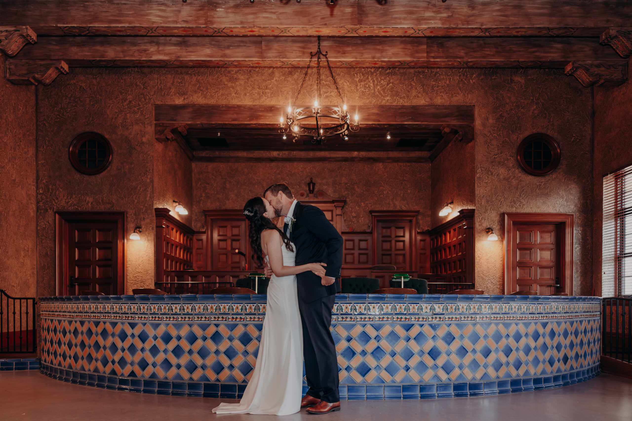 Liza and Will walking through the sunken garden courtyard at the Sarasota Historic Courthouse