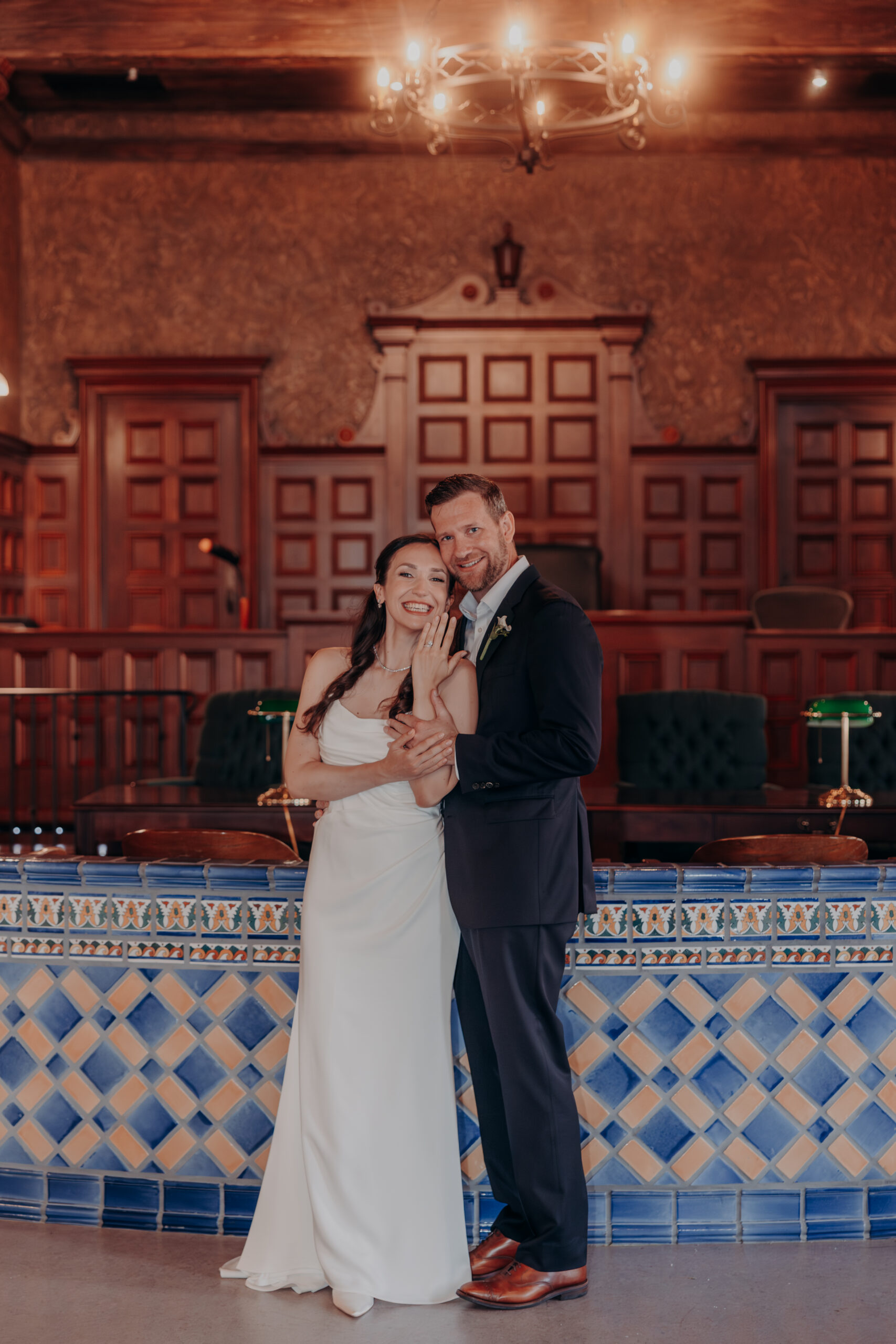 Liza looking over her shoulder at Will with a smile during Sarasota courthouse wedding portraits