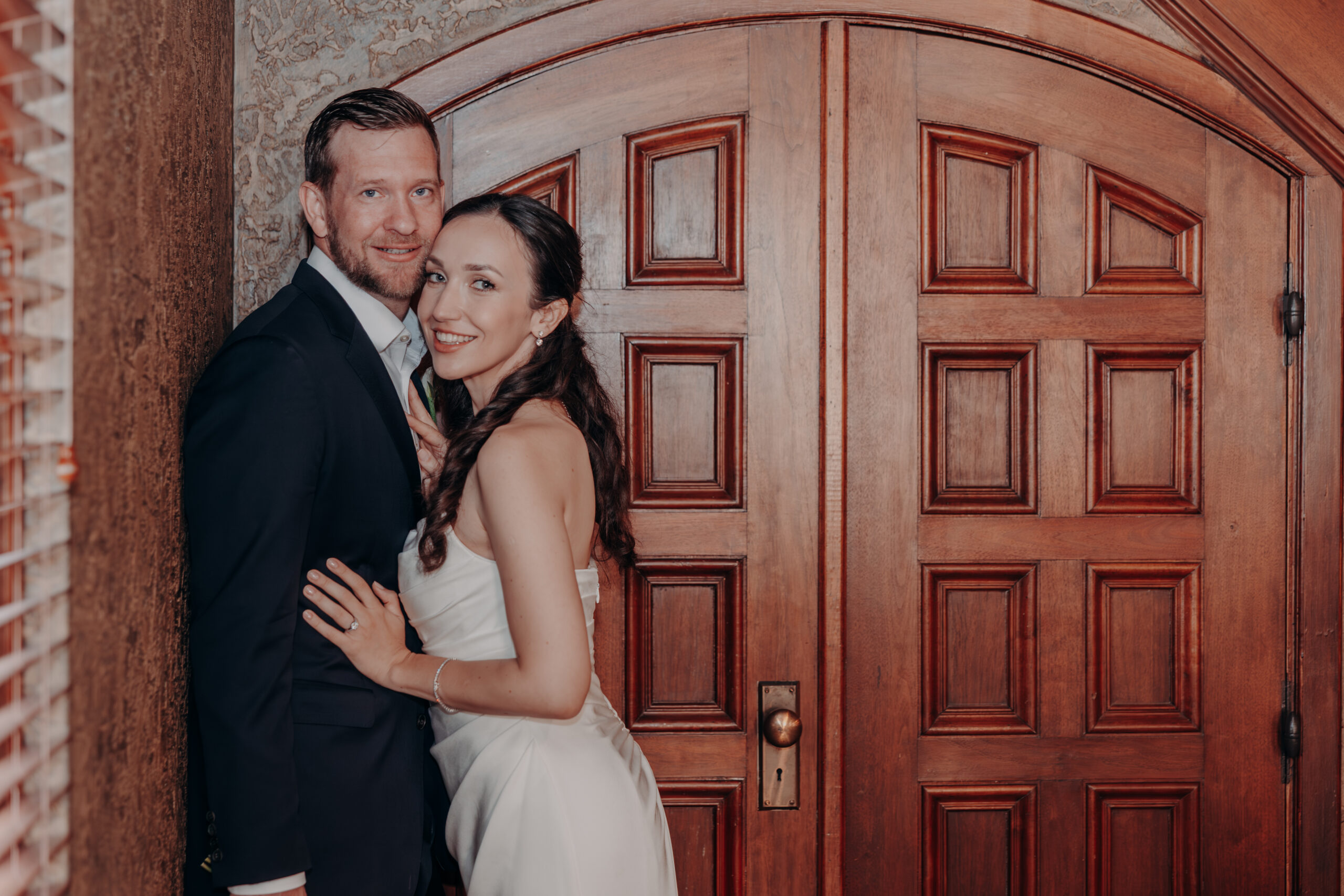 Will and Liza laughing during couples portraits outside the Sarasota Historic Courthouse Sarasota FL