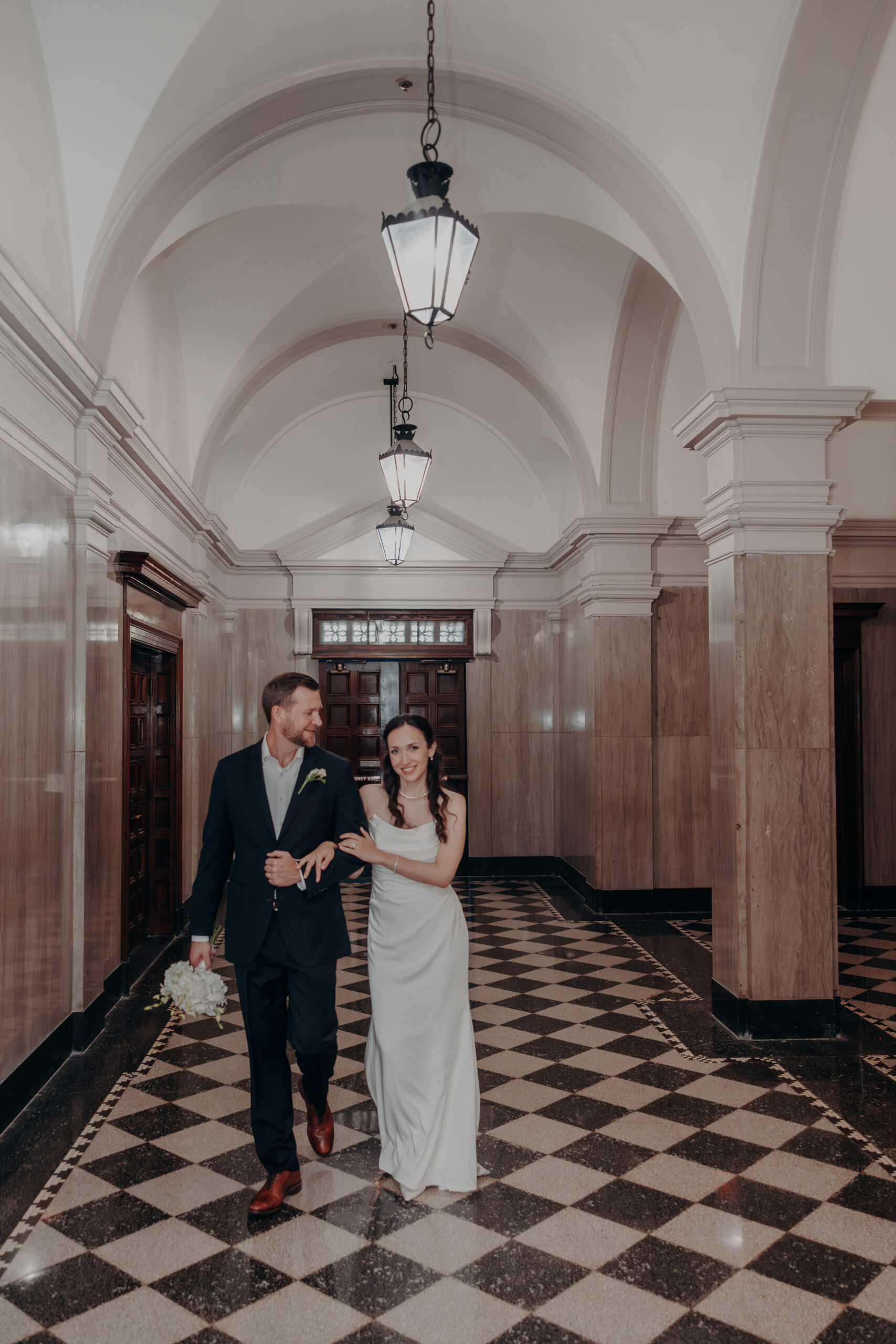 Liza gazing toward the courthouse entrance in a candid moment during her Sarasota FL wedding