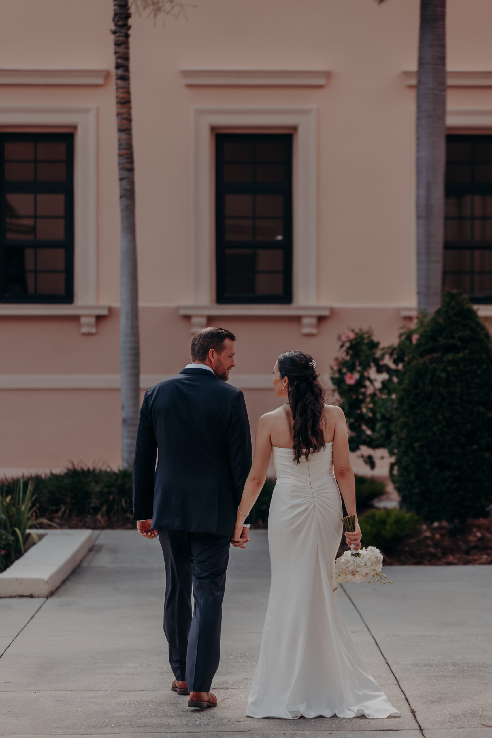 Liza pressing her hand to Will's chest during a tender moment at the Historic Sarasota County Courthouse