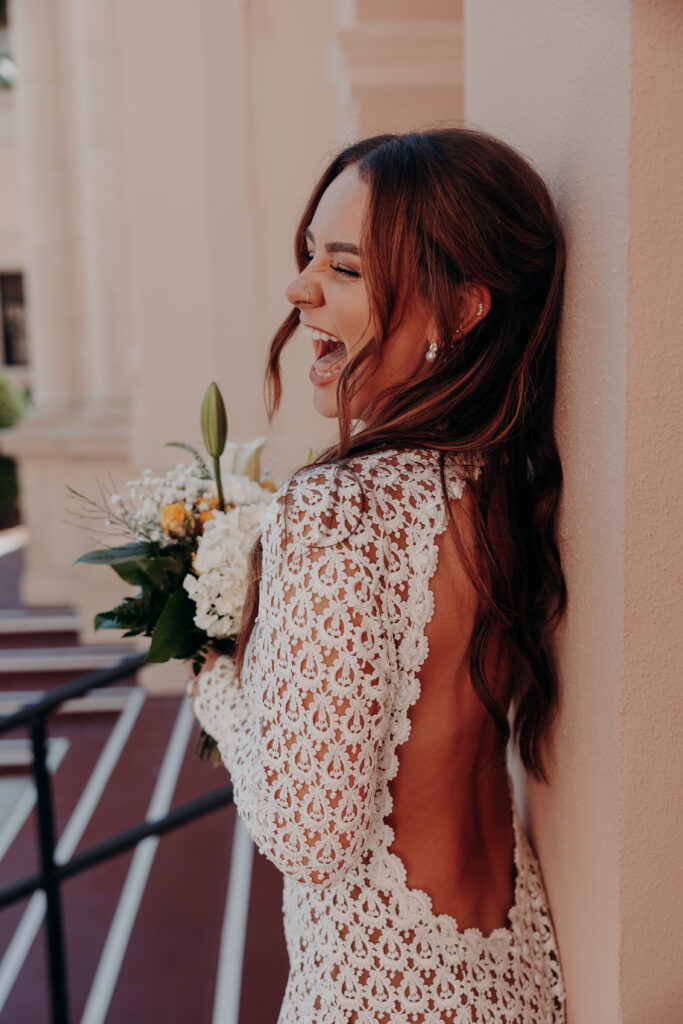 Mikaely laughing with pure joy in a candid outdoor portrait during her Sarasota Florida courthouse elopement