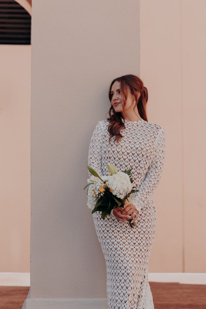 Elegant side profile portrait of Mikaely in her Anthropologie lace wedding gown at the Historic Sarasota County Courthouse in Sarasota Florida