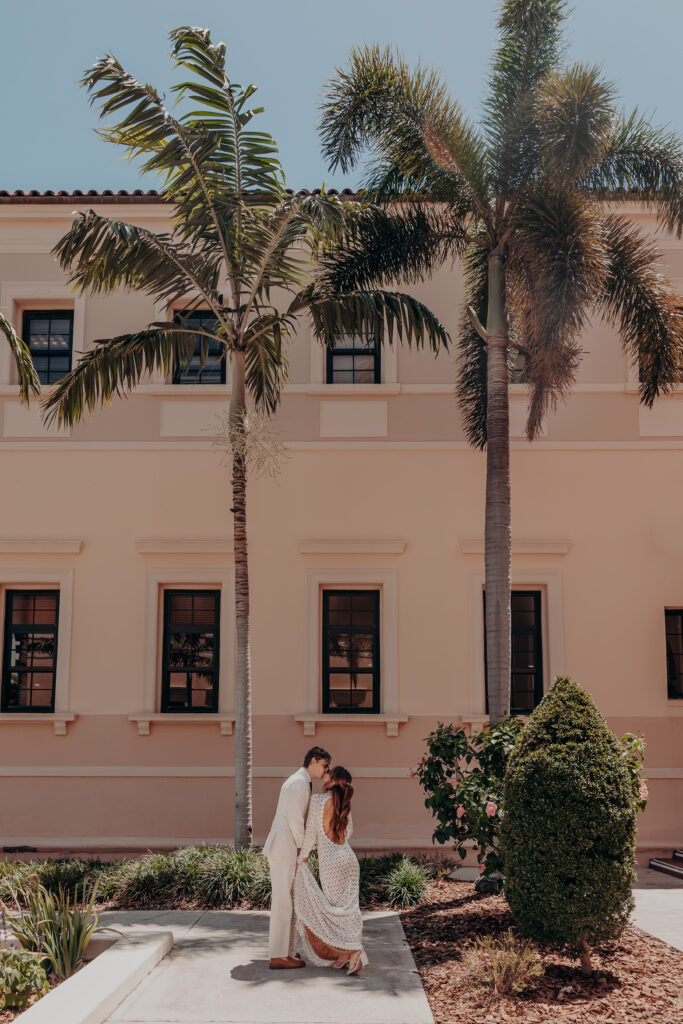 Exterior of the Historic Sarasota County Courthouse surrounded by Florida palm trees during Mikaely and Chris elopement