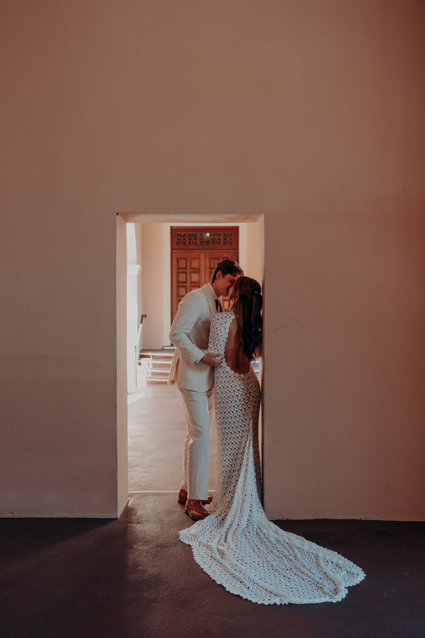 Mikaely and Chris sharing a kiss framed in a courthouse doorway during their Sarasota courthouse elopement