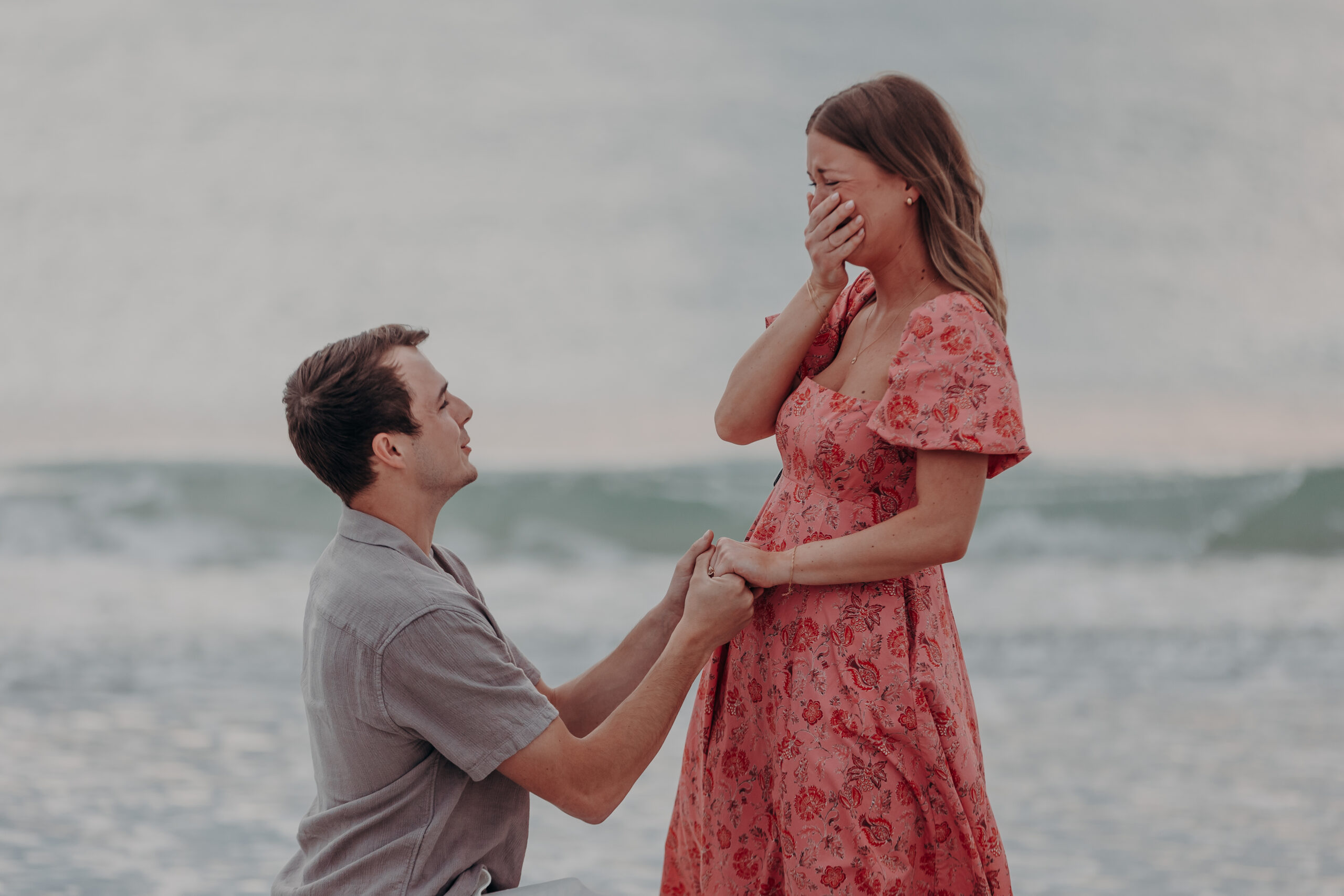 Sarasota proposal photographer Angela Moon captures couple Dylan and Megan walking together on Lido Beach at golden hour Sarasota Florida