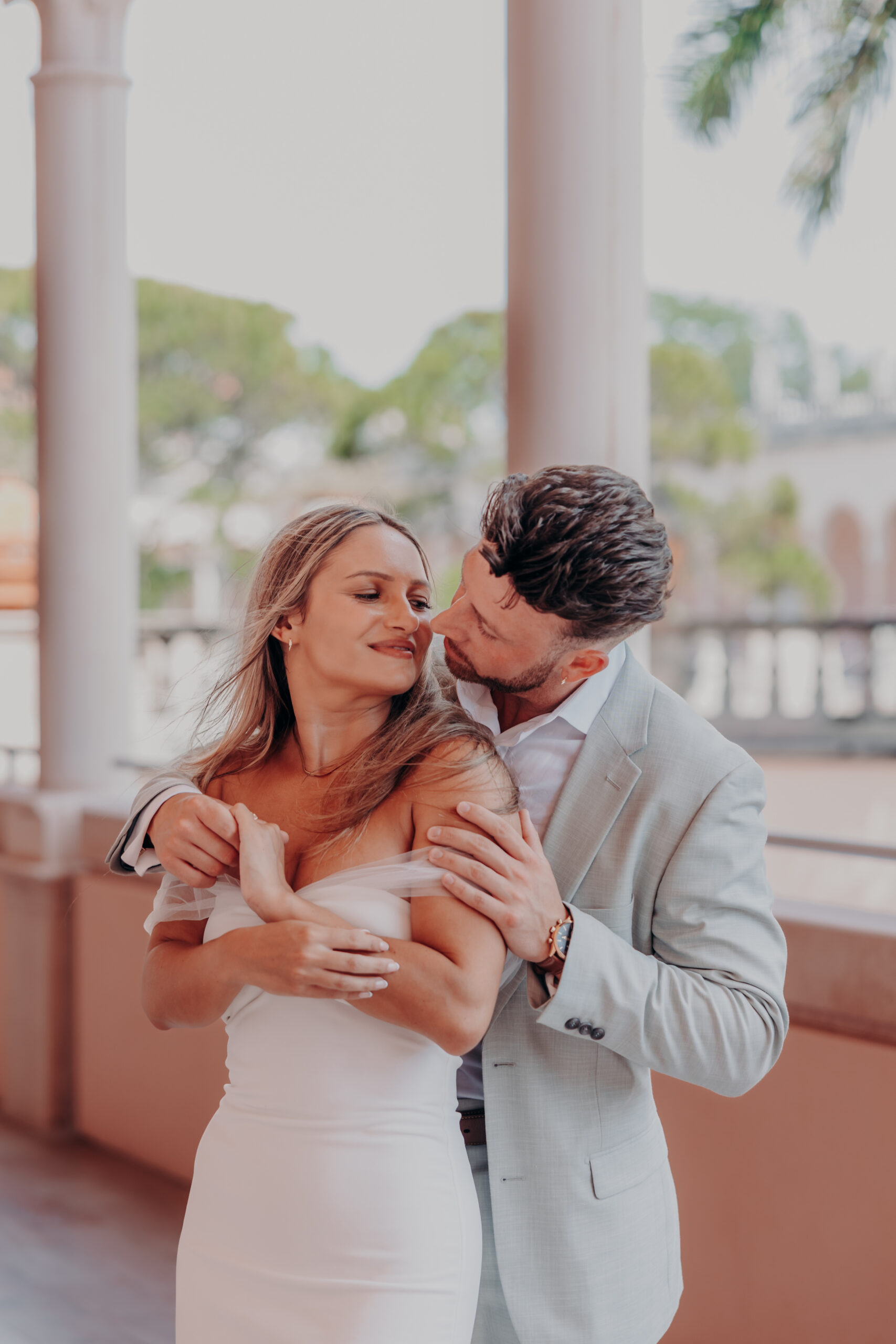 Nicole and Gabe kissing under the loggia at the Ringling Museum of Art Sarasota Florida engagement