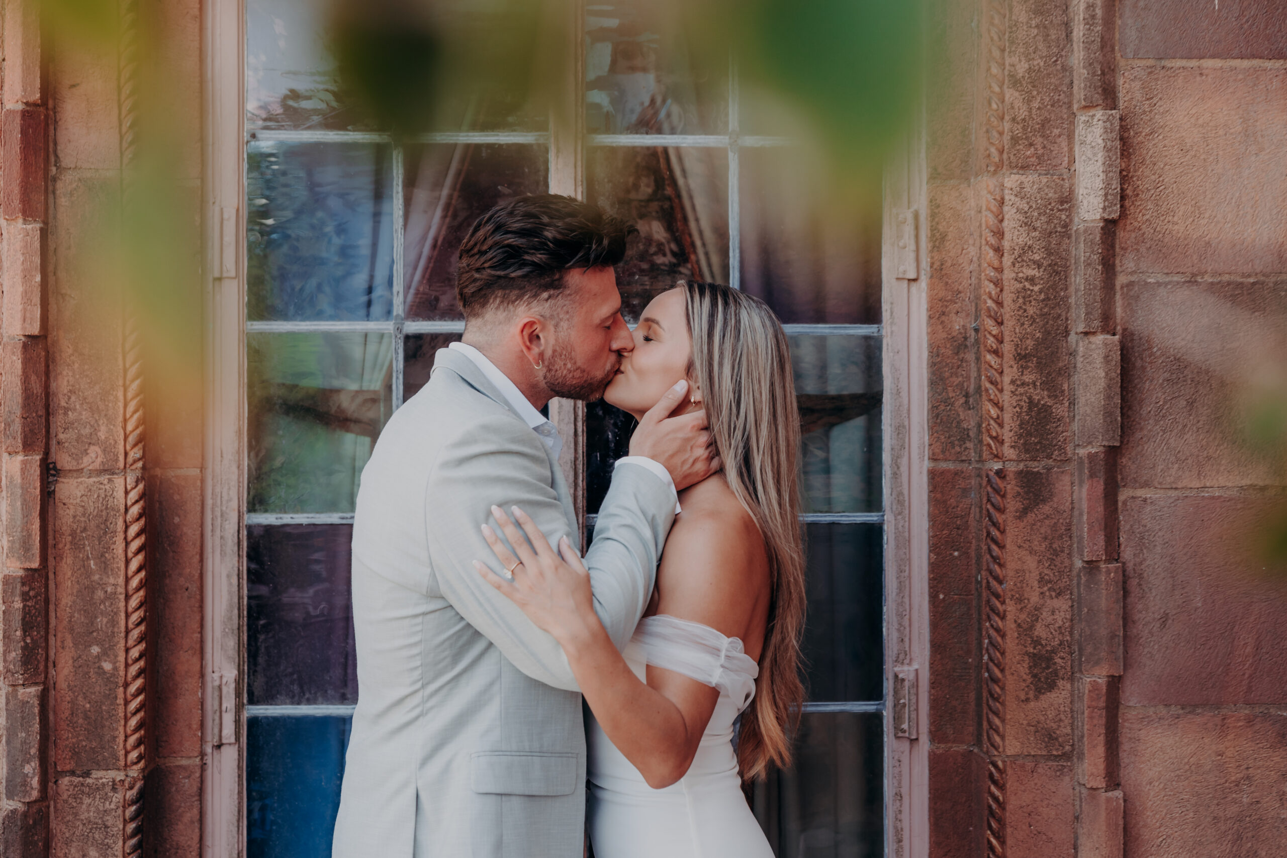 Couple under the pink arches at the Ringling Museum of Art Sarasota Florida engagement photographer