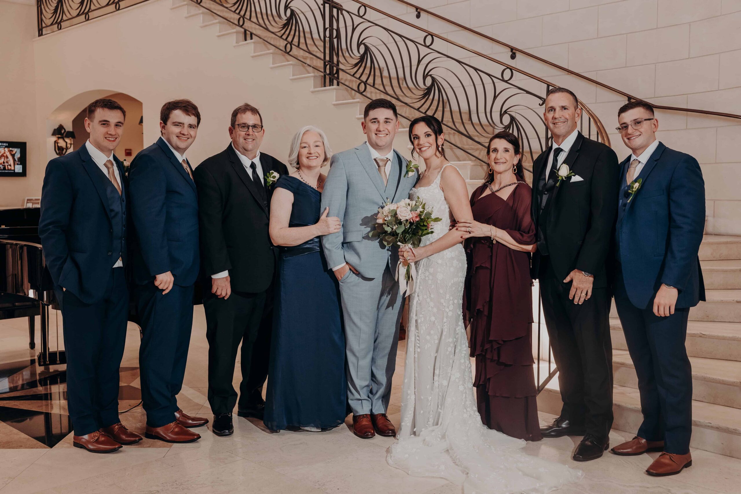 Groom Ryan with his brothers and groomsmen on the grand staircase at Lakewood Ranch Golf and Country Club