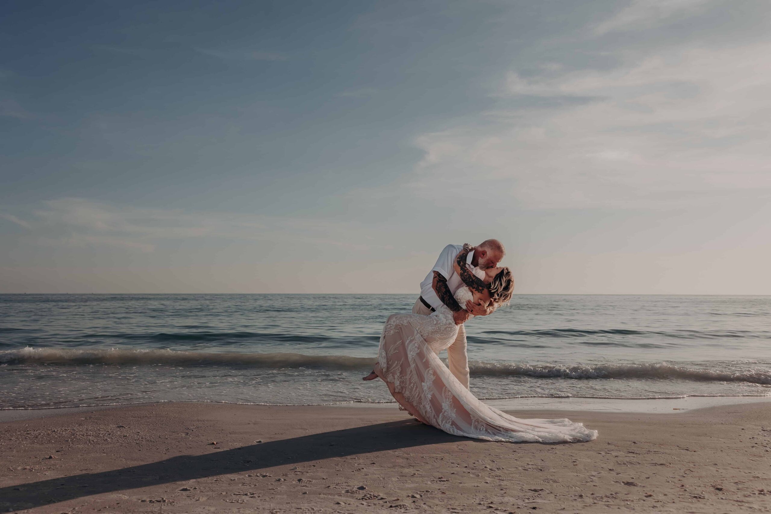 Couple dip silhouette Siesta Key beach sunset elopement Sarasota Florida