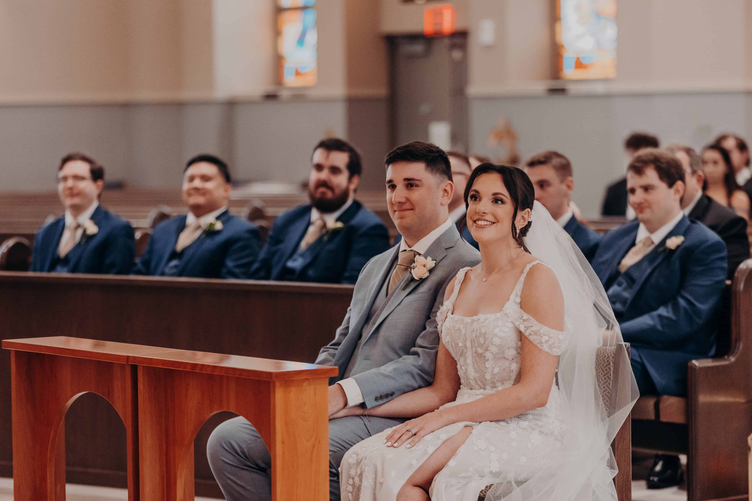 Bride and groom kneeling at the prie-dieu during their Catholic wedding ceremony at Our Lady of the Angels in Lakewood Ranch Florida
