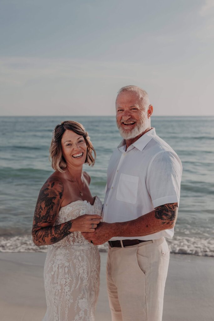 Bride and groom laughing together beach elopement Siesta Key Sarasota