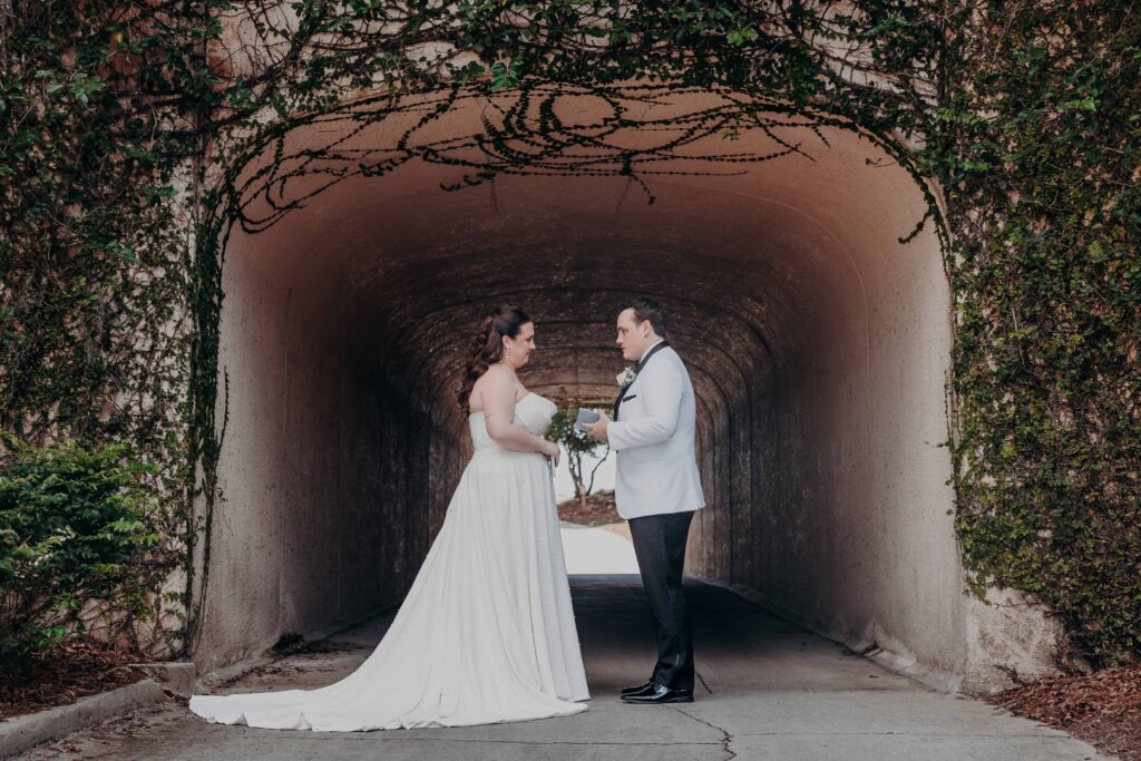 Bride and groom sharing private vows in ivy-covered tunnel at Lakewood Ranch Golf and Country Club