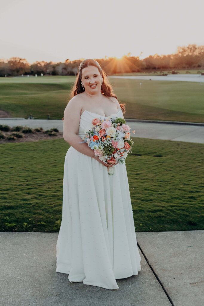 Bride in pearl wedding gown at golden hour on golf course at Lakewood Ranch Golf and Country Club
