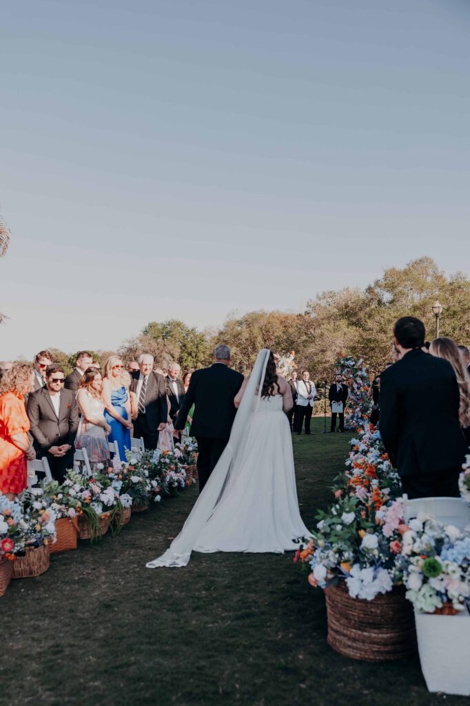 Bride walking down the aisle with her father at Lakewood Ranch Golf and Country Club outdoor ceremony
