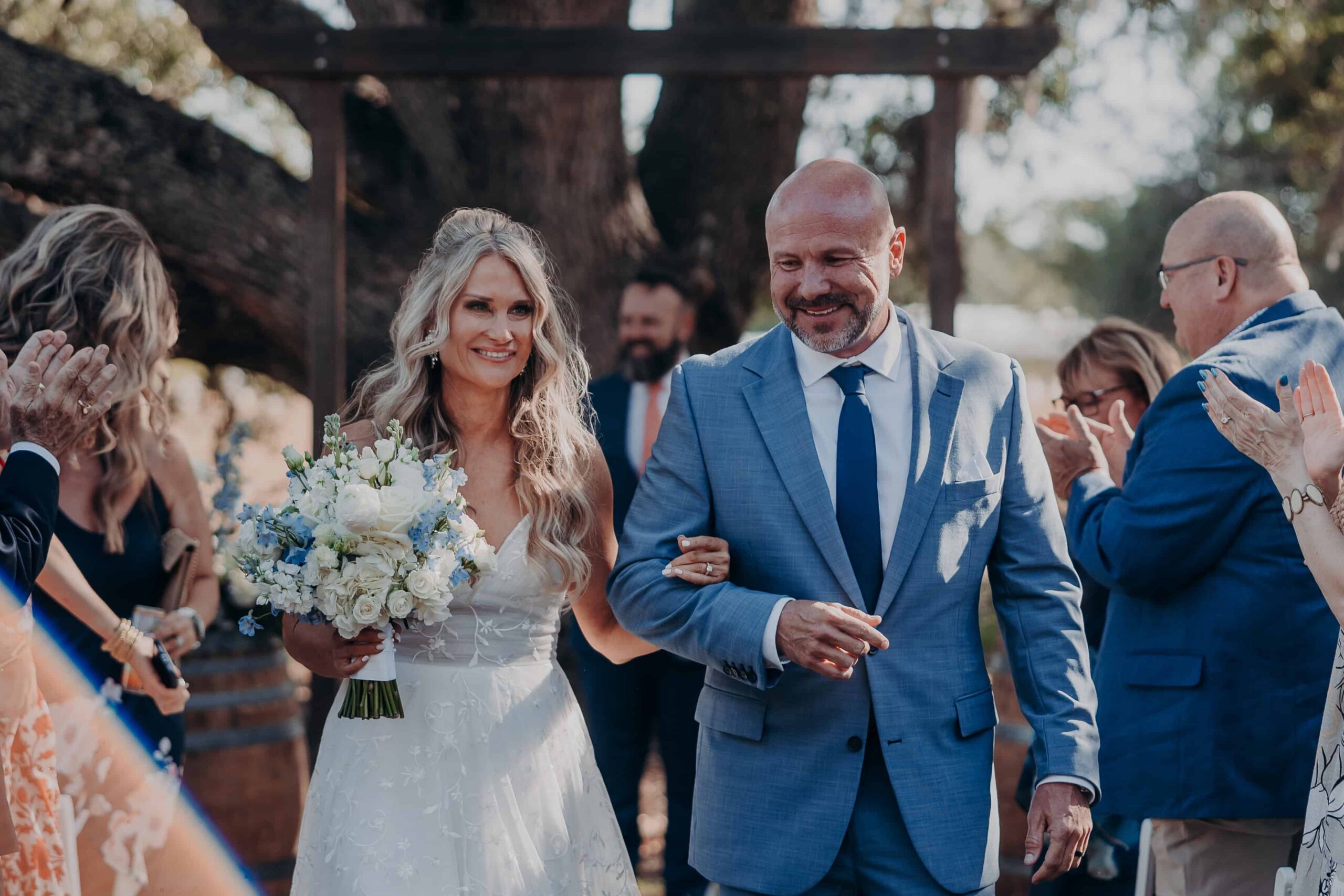 Bride and groom ceremony recessional exit through pergola at Browns Grove Farm in Parrish FL