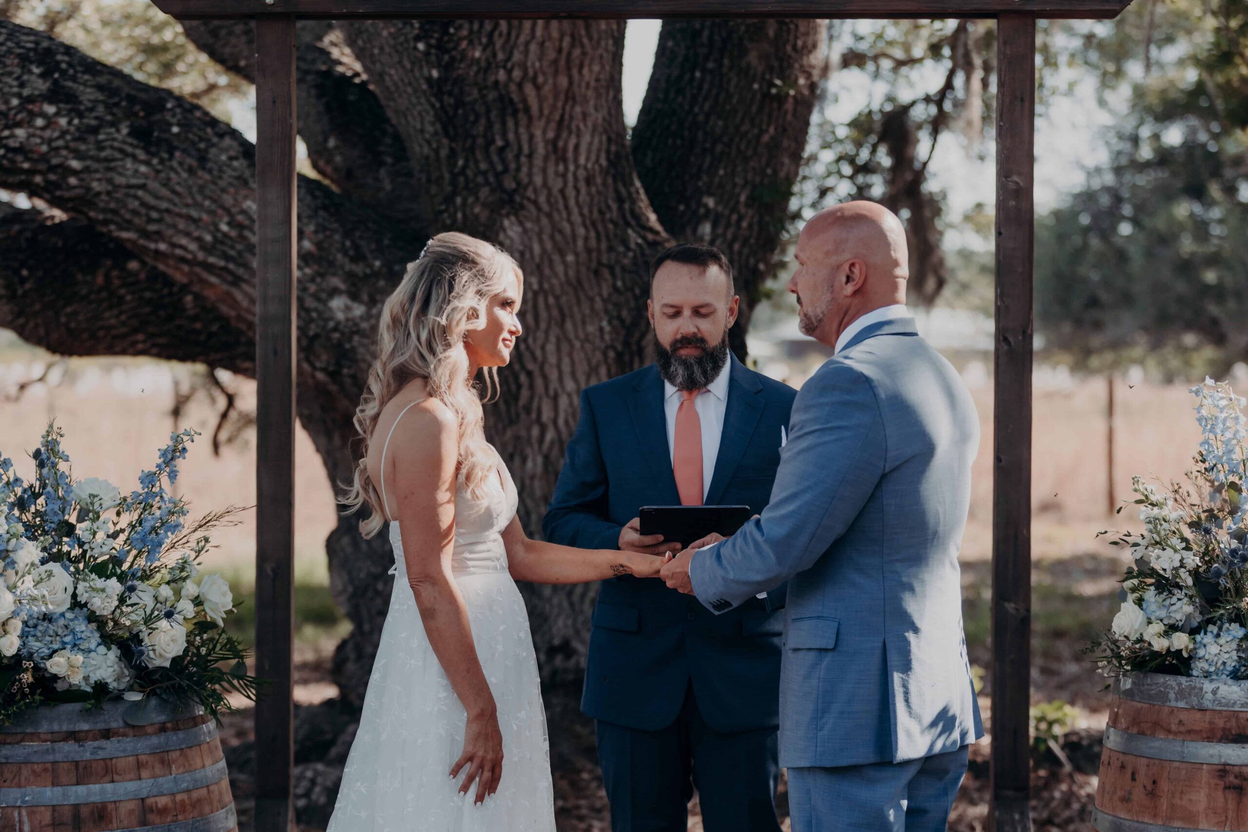 Bride and groom hands clasped at altar during vows Brown's Grove Farm wedding