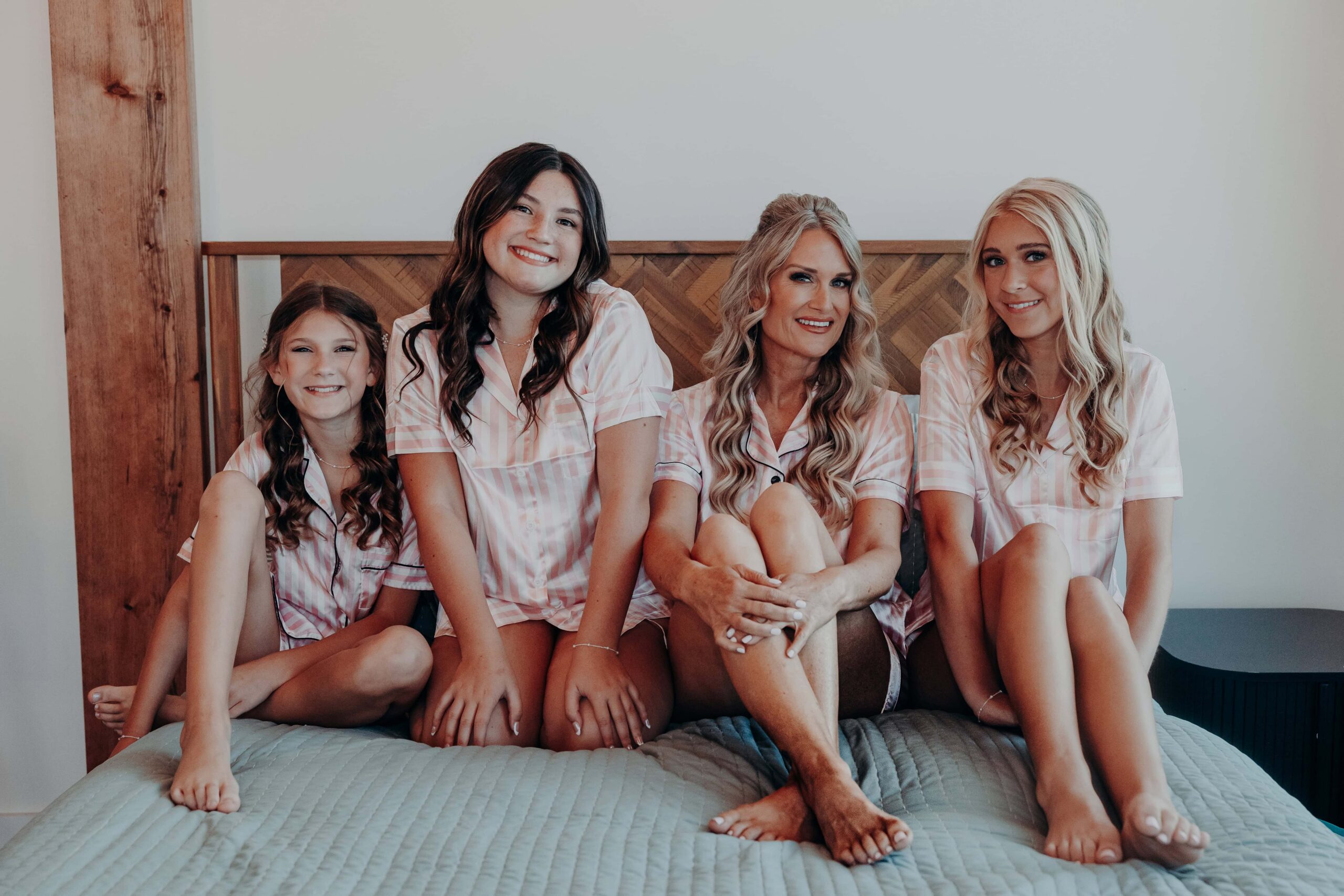 Bride Debbie and three daughters in matching pink plaid pajamas getting ready at Brown's Grove Farm wedding