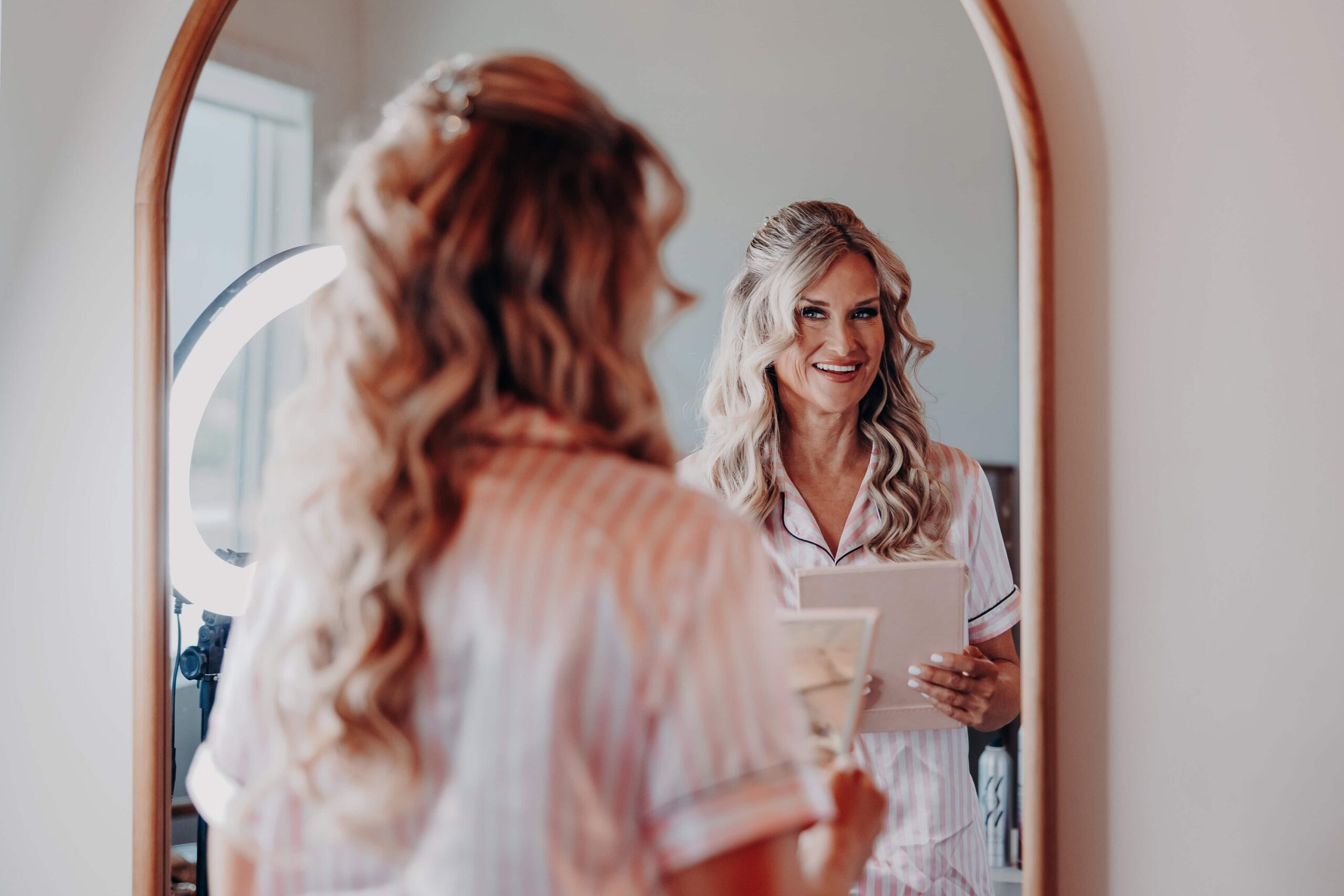 Bride reading heartfelt letter in mirror reflection at Brown's Grove Farm wedding getting ready