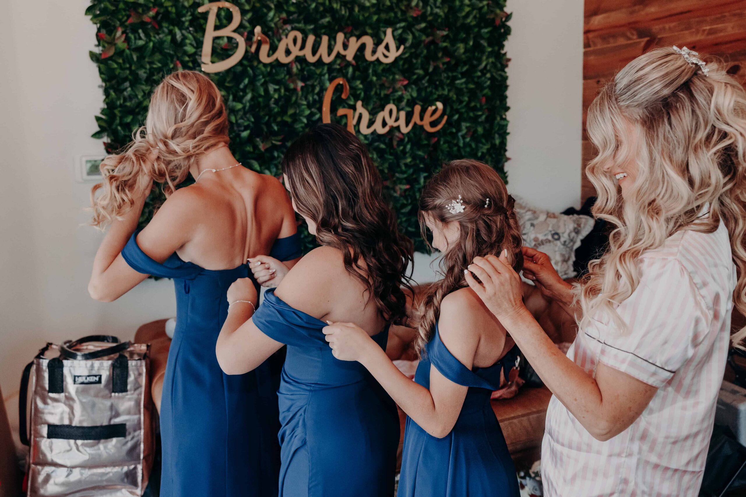 Bridesmaids holding Brown's Grove sign before wedding ceremony Parrish Florida